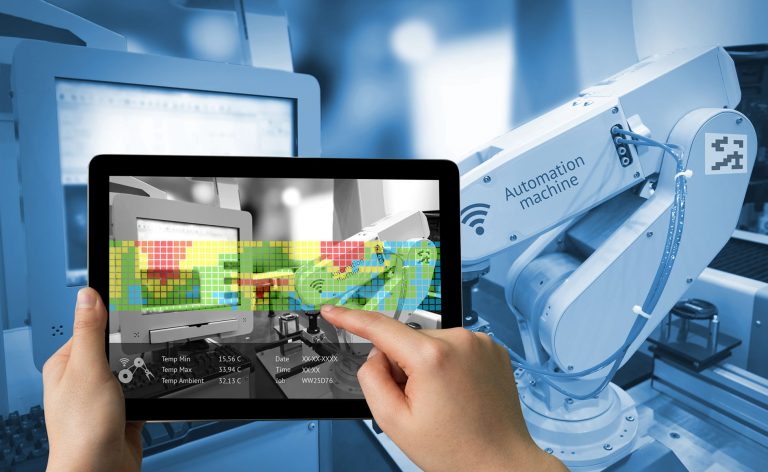 Industry 4.0 concept .Man hand holding tablet with Augmented reality screen software and blue tone of automate wireless Robot arm in smart factory background